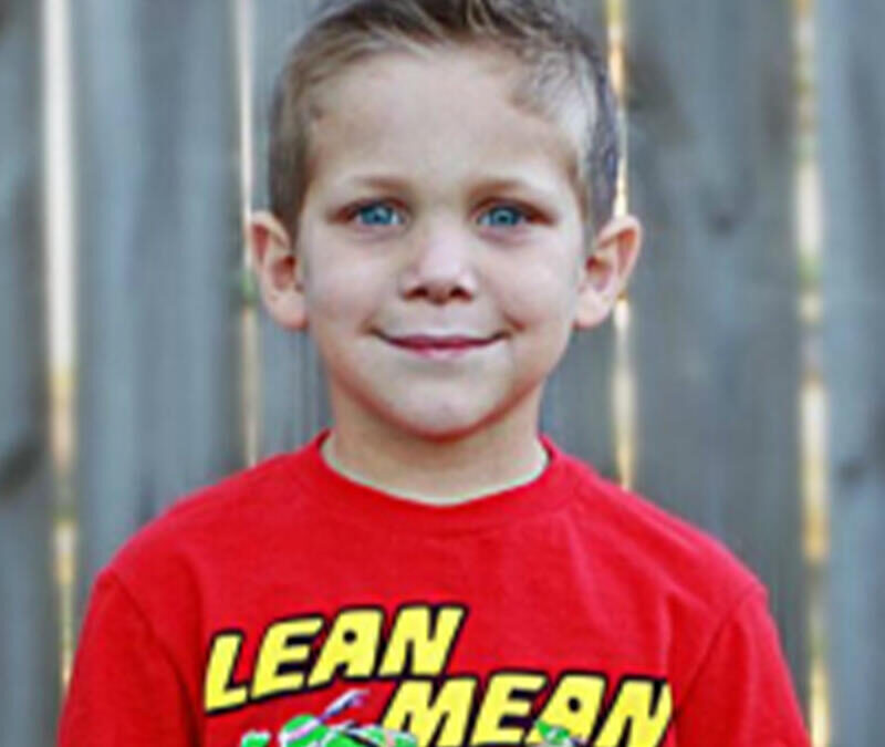 A young boy wearing a lean mean t - shirt.