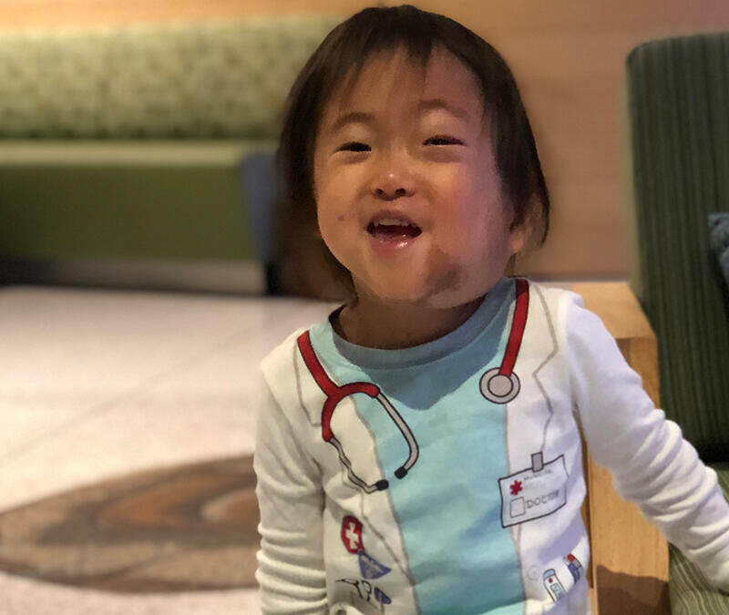 A child smiling at the camera.