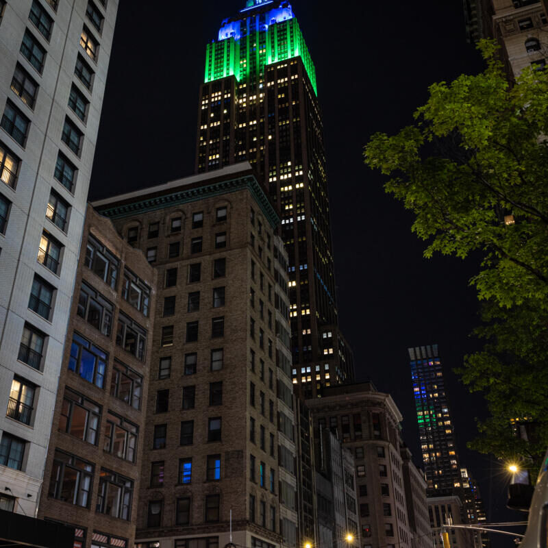 The building is lit up blue and green.