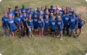 A group of people in blue t - shirts posing for a photo.