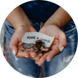 A woman's hands holding coins and a note that says make a loan.