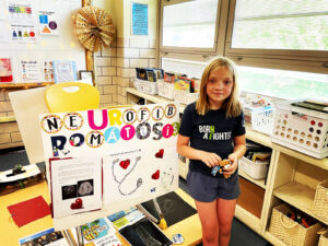 A girl standing in a classroom.