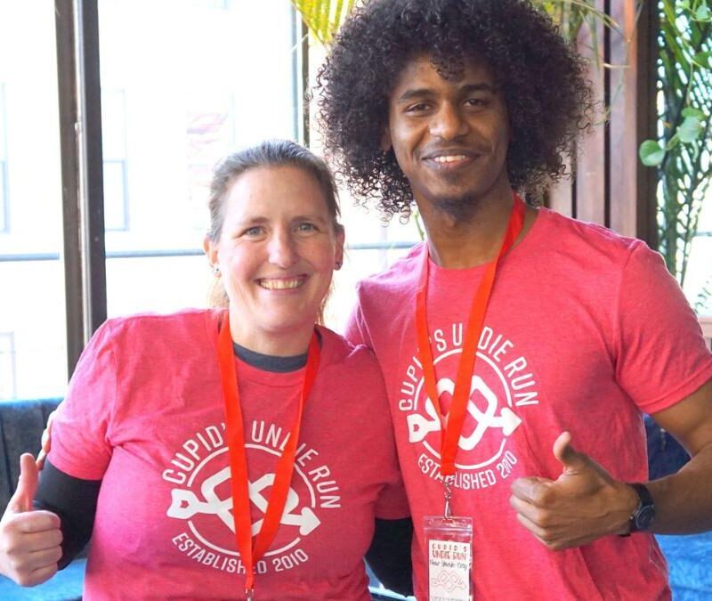 Two people in pink shirts posing for a picture.