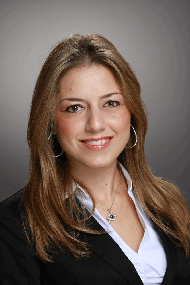 A woman in a business suit posing for a photo.