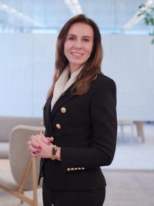A woman in a business suit standing in an office.