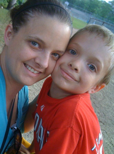 A woman and a young boy posing for a picture.