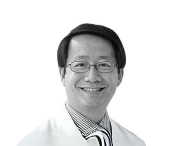 A black and white photo of a man in a lab coat.
