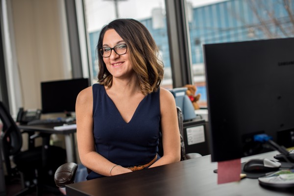 woman smiling sitting at desk in office