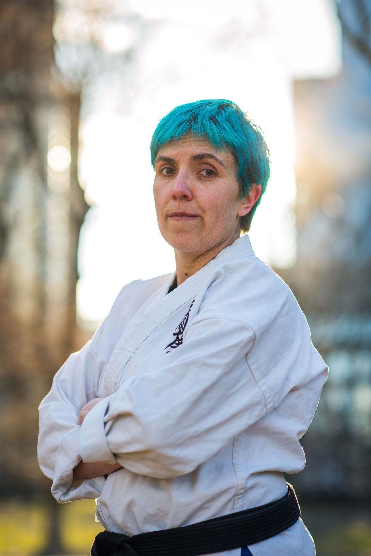 A woman with blue hair in a karate uniform.