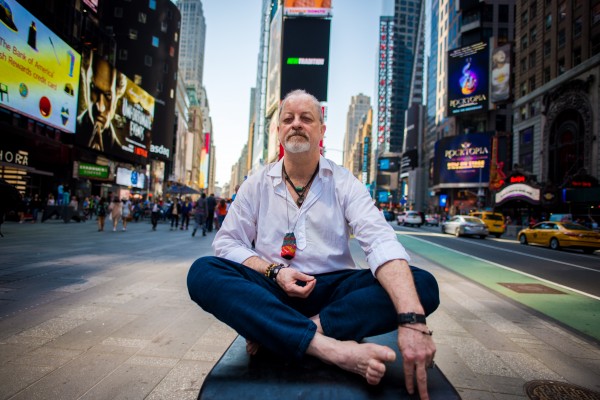 A man sitting on a bench in times square.