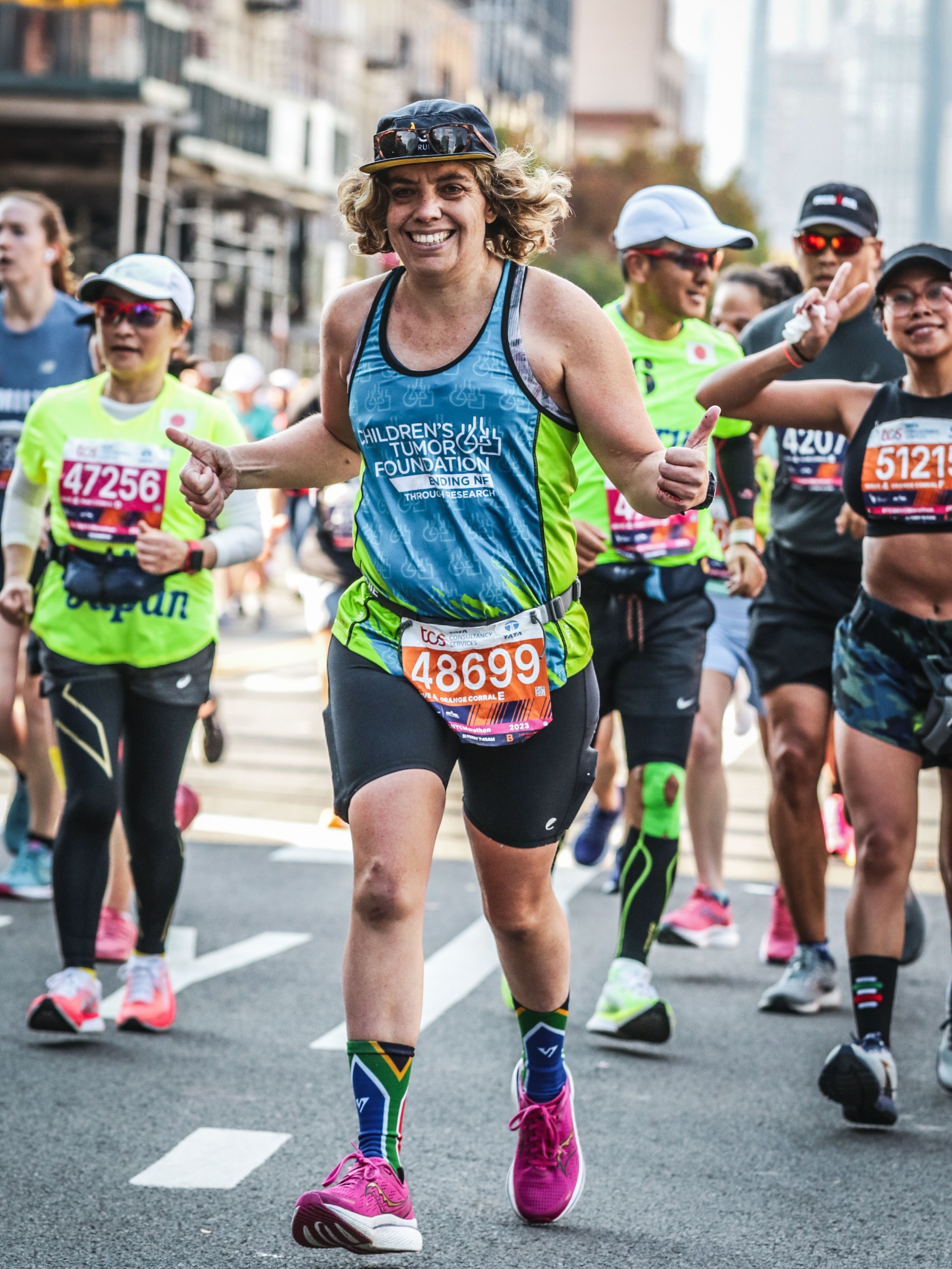 A group of people running in a city.