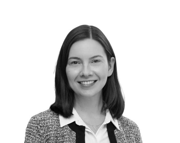 A black and white photo of a woman smiling.