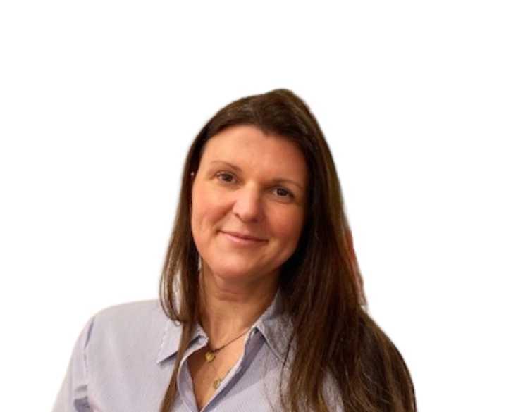 A woman in a blue shirt smiling for the camera.