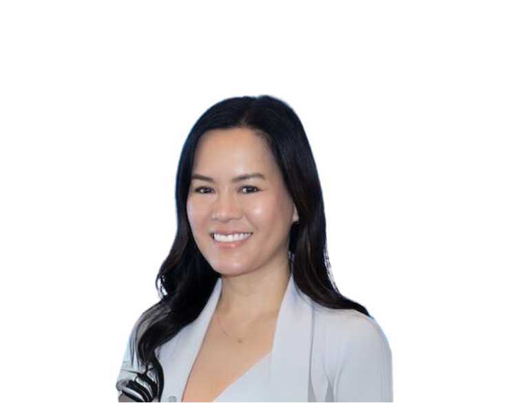 A smiling woman in a gray blazer.