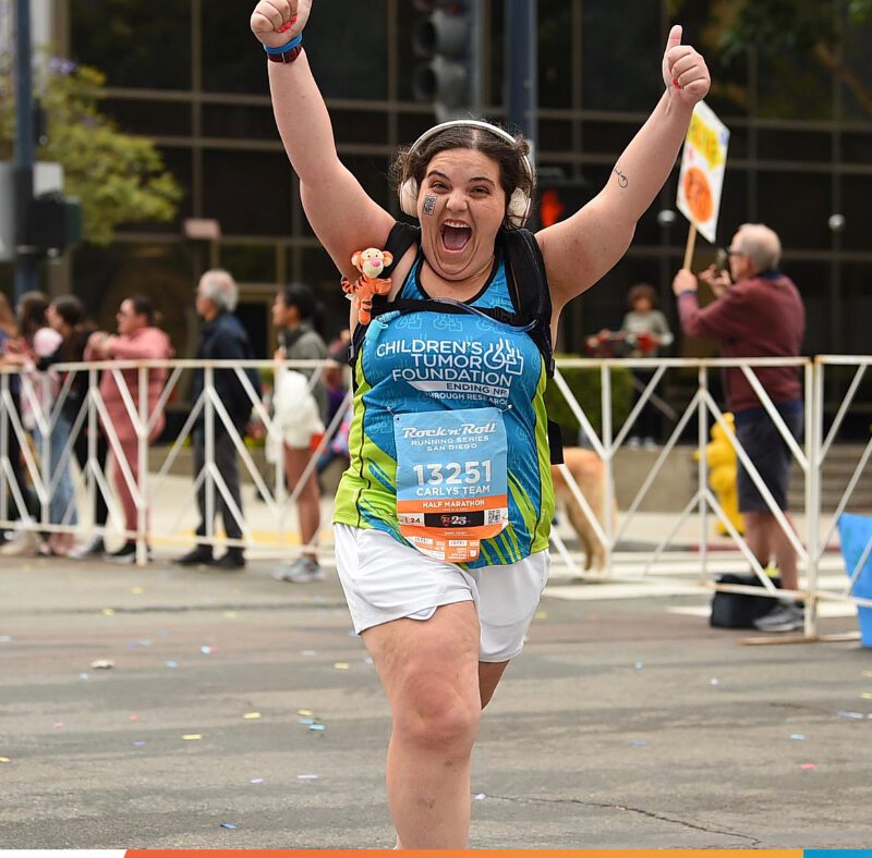 Woman Running a race with CTF Shirt