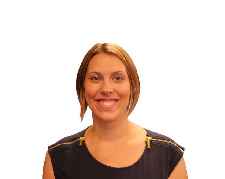 A woman in a blue shirt smiling for the camera.