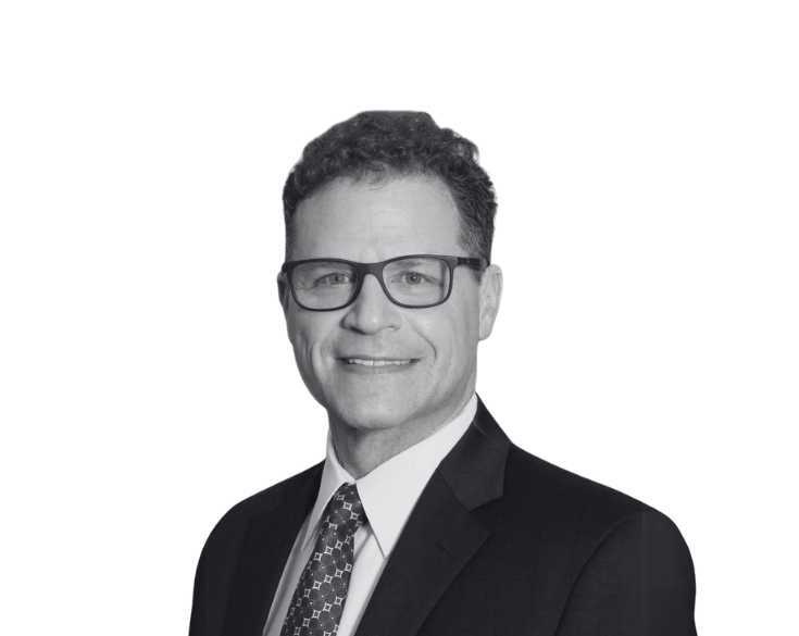 A black and white photo of a man in a suit and tie.