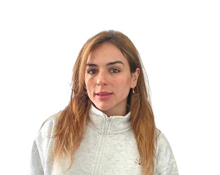 A woman in a grey sweatshirt posing for a photo.