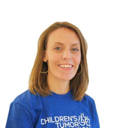 A woman wearing a blue t - shirt with the word children's aid on it.