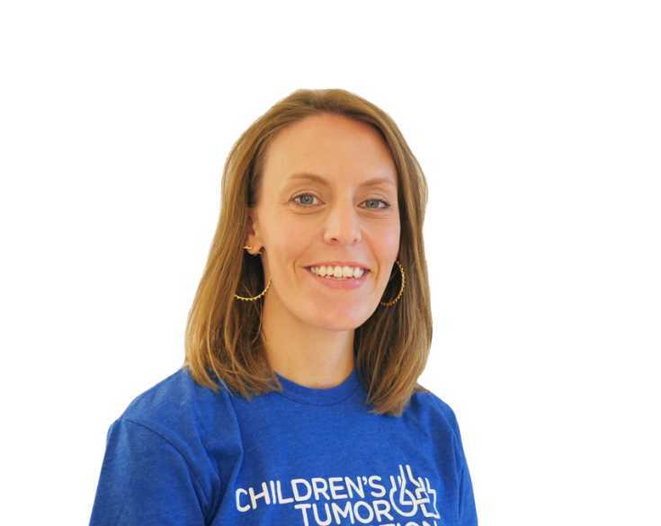 A woman wearing a blue t - shirt with the word children's aid on it.