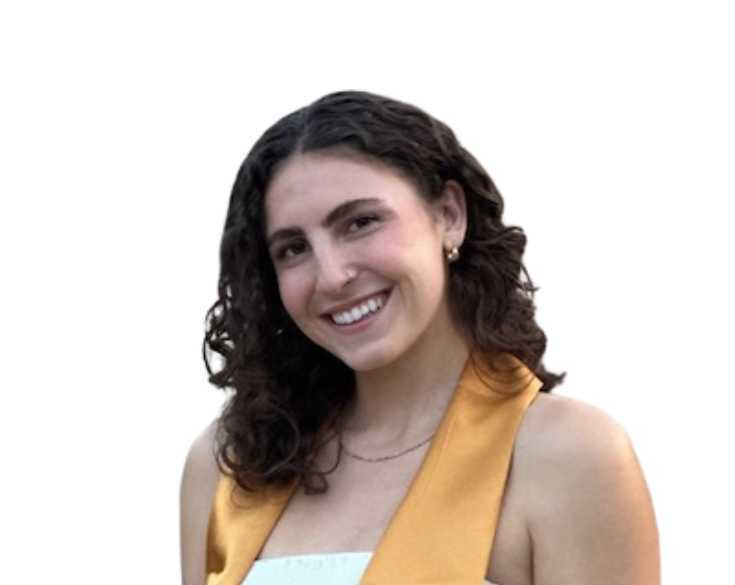 A woman in a graduation gown smiling.