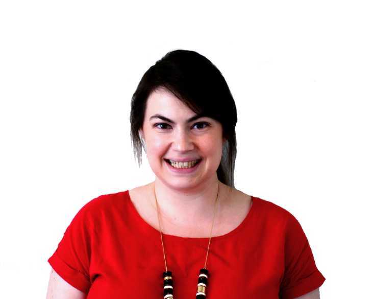 A woman wearing a red top and necklace.