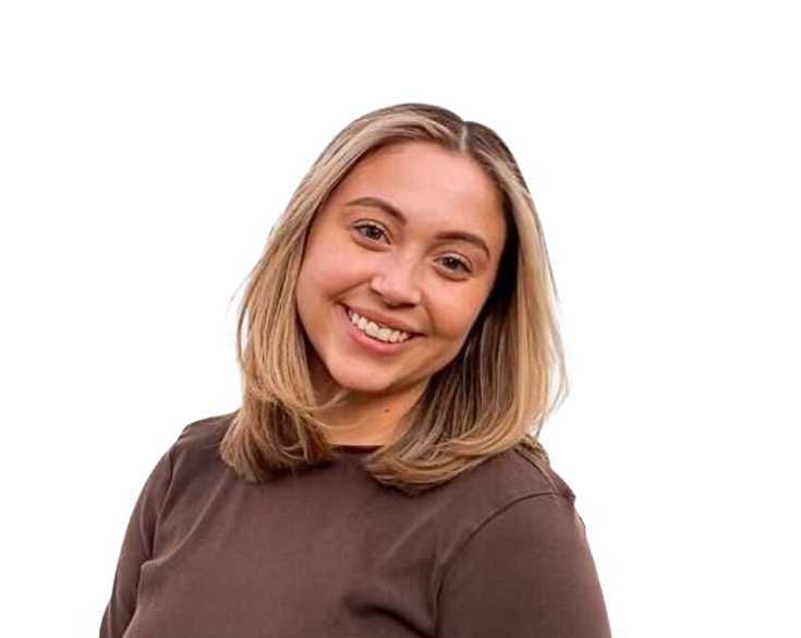 A woman in a brown shirt smiling for the camera.