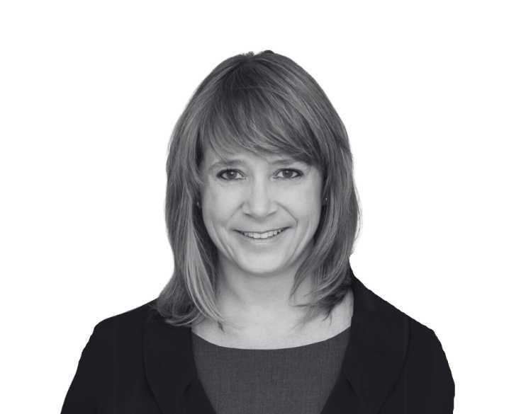 A black and white photo of a woman smiling.