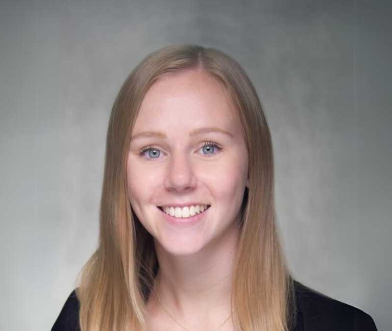 A woman with blonde hair smiling for the camera.