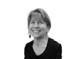 A black and white photo of a woman smiling.