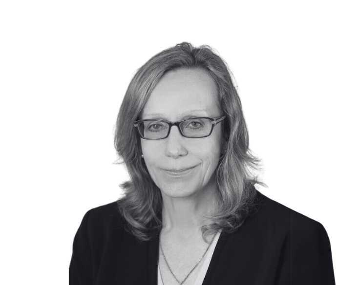 A black and white photo of a woman wearing glasses.