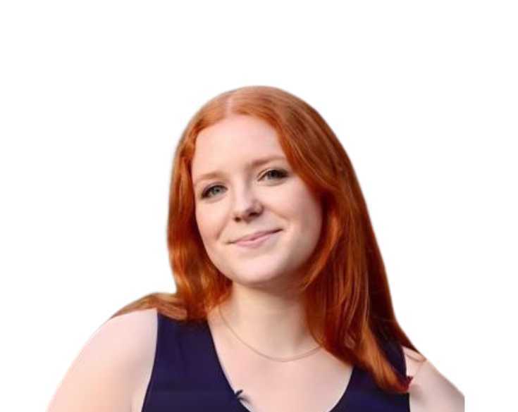 A woman with red hair is smiling in front of a white background.
