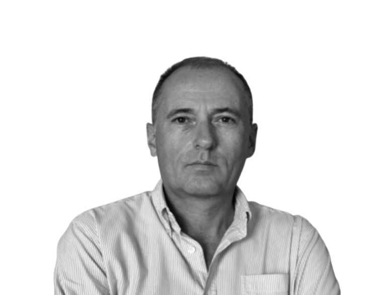 A black and white photo of a man in a white shirt.