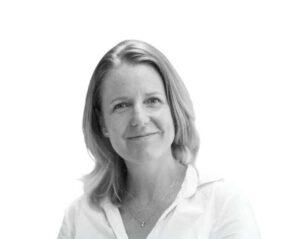 A black and white photo of a woman in a white shirt.