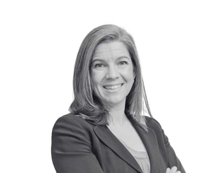 A black and white photo of a woman in a business suit.