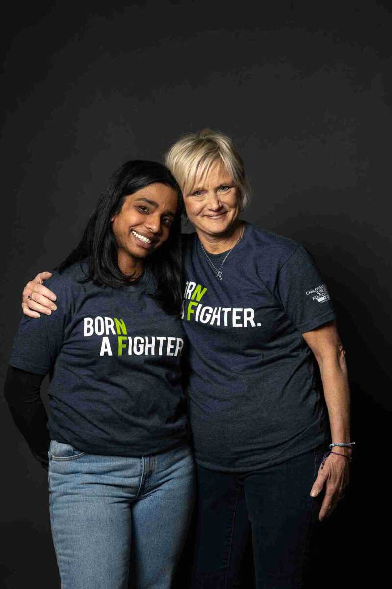 Two women wearing t - shirts that say born a fighter.