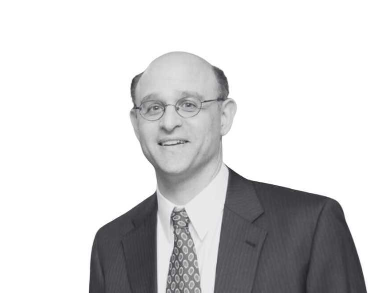 A black and white photo of a man in a suit and tie.