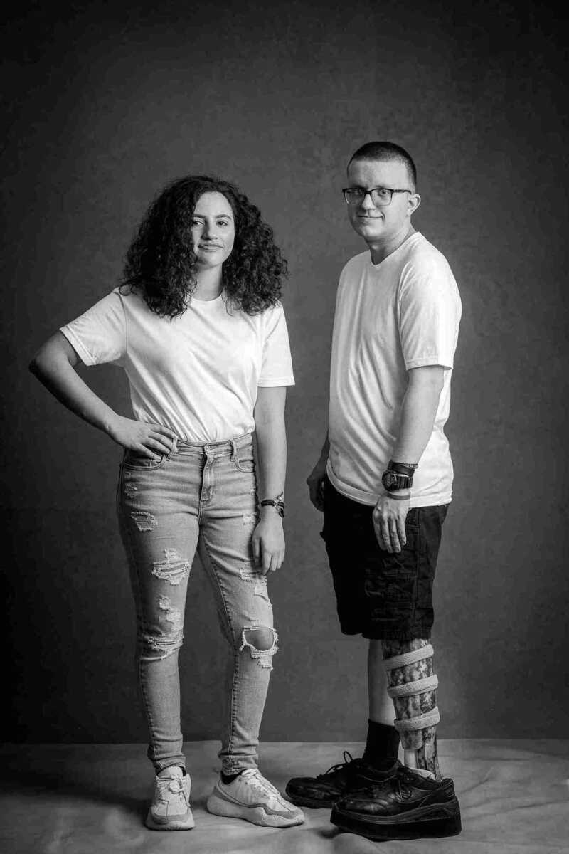 A black and white photo of a man and woman posing for a photo.