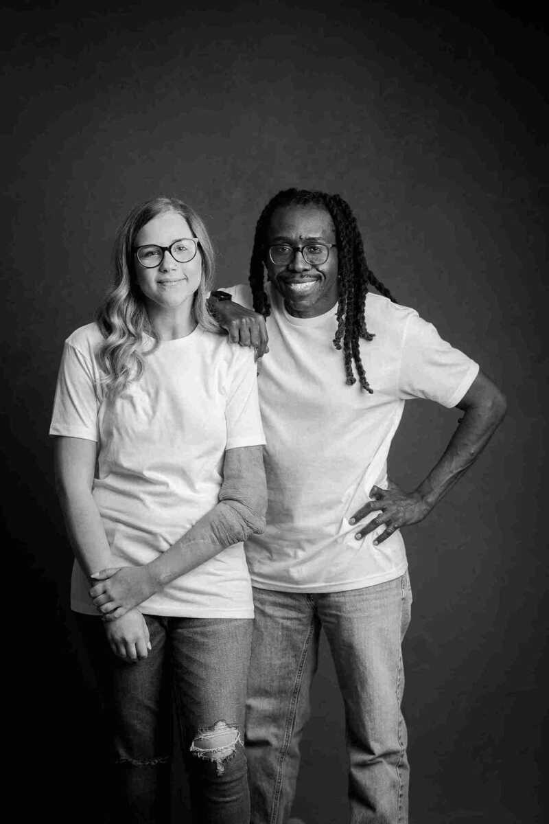 A black and white photo of a man and woman posing for a photo.