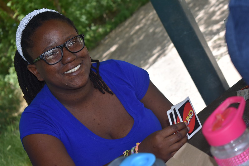 girl playing cards smiling at camera