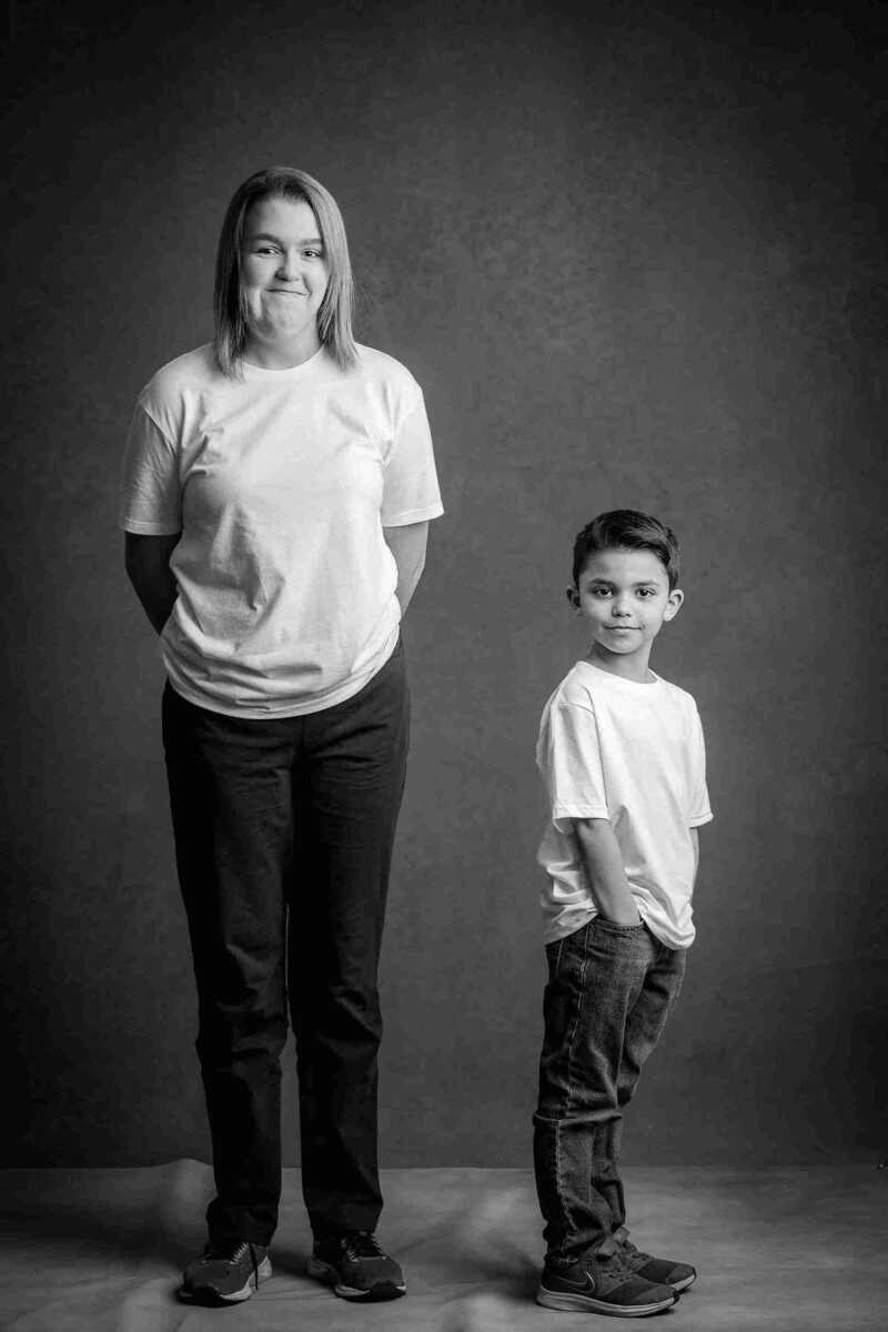 A black and white photo of a woman and a boy.