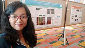 Researcher in front of scientific poster