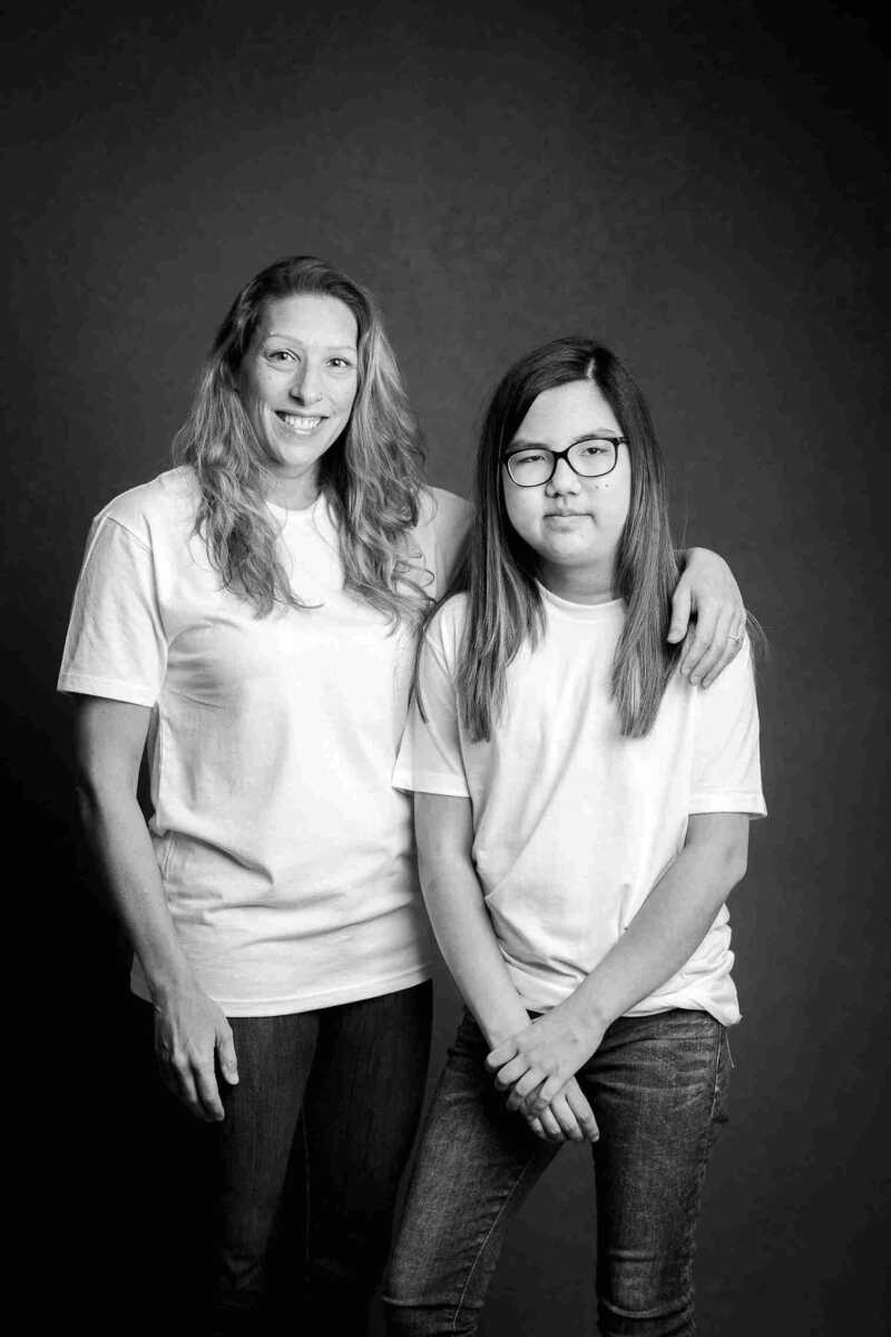 Two women posing for a black and white photo.