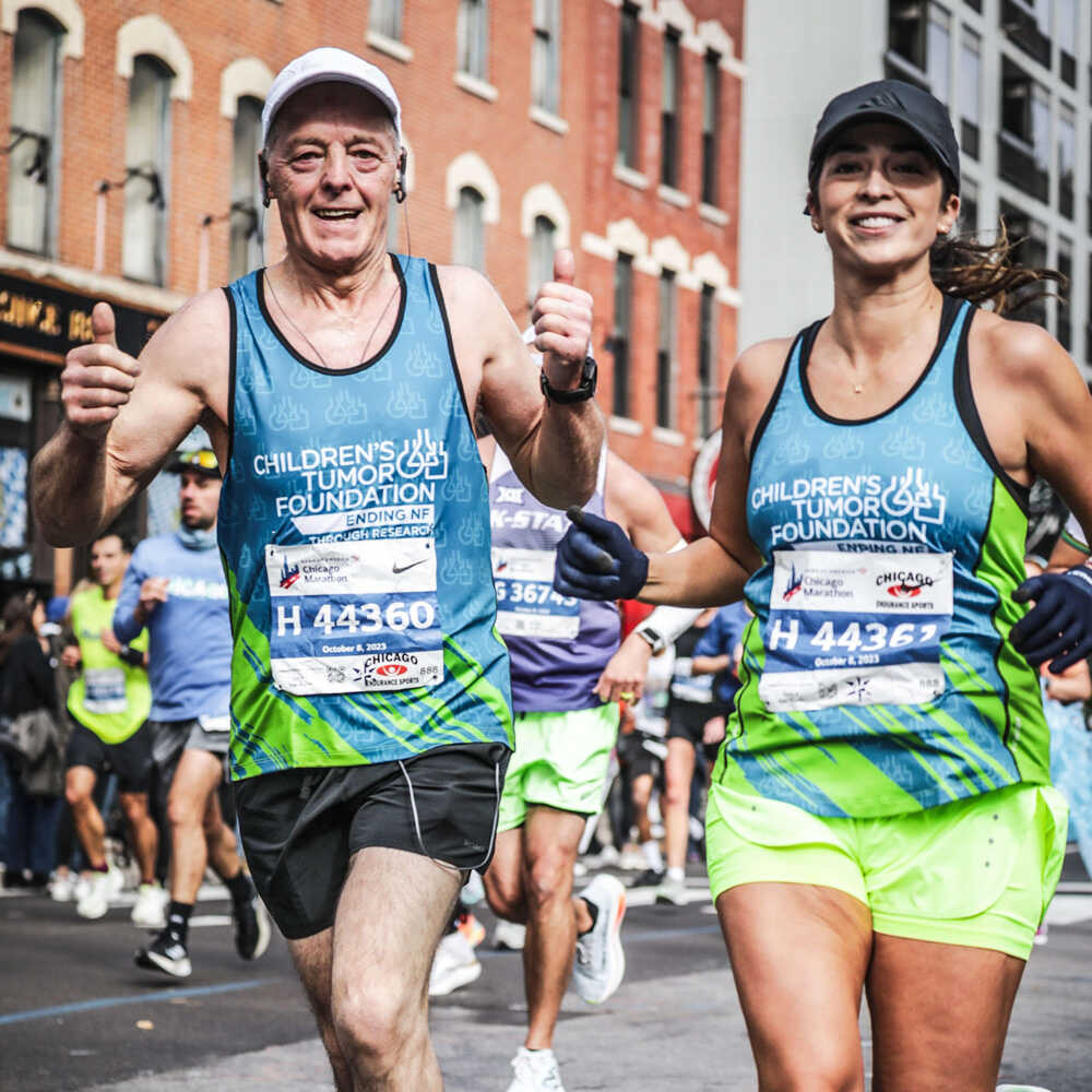 A man and woman running in a marathon.