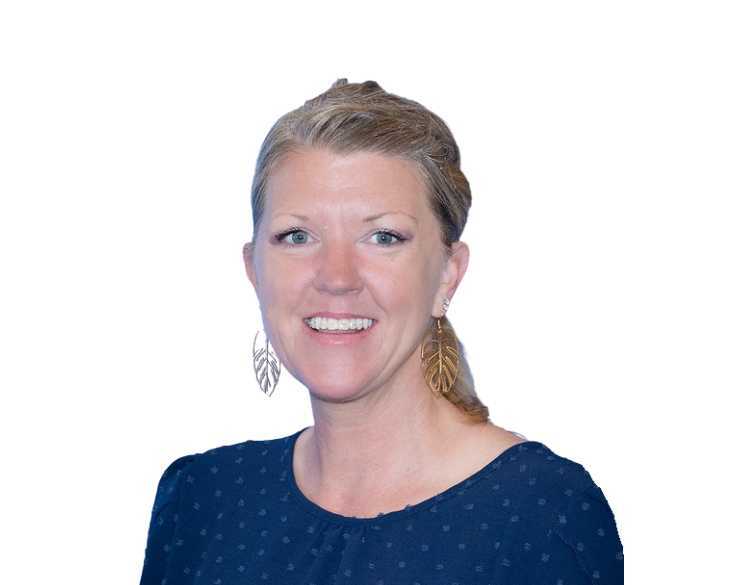 A woman wearing a blue top and earrings.