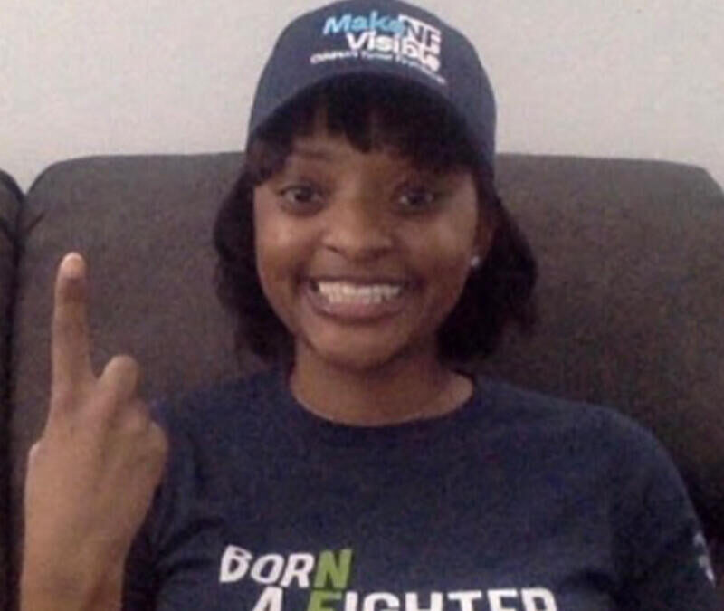 A young woman wearing a hat and a t - shirt.