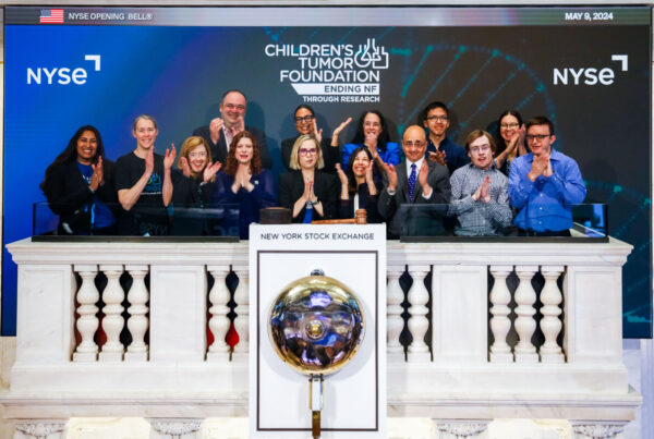 Group of people celebrating at the New York Stock Exchange for the Children's Tumor Foundation event.