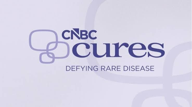 CNBC Cures logo with the tagline “Defying Rare Disease” and abstract rounded square designs in the background.
